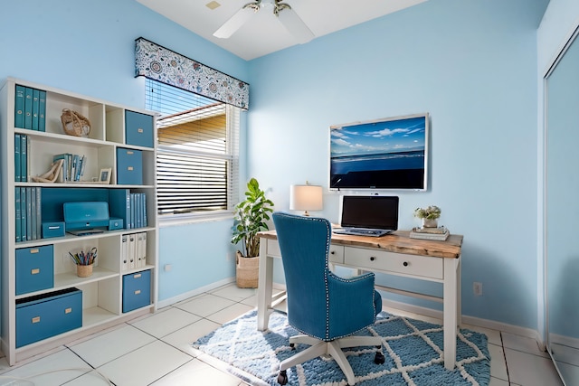 office area featuring light tile patterned floors, ceiling fan, and baseboards