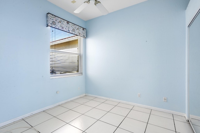 empty room featuring a ceiling fan and baseboards