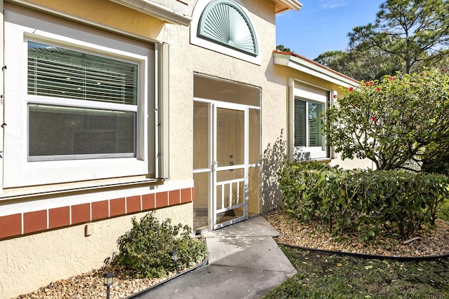 entrance to property with stucco siding