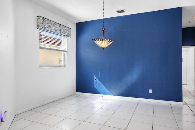 unfurnished dining area with visible vents, baseboards, and tile patterned floors