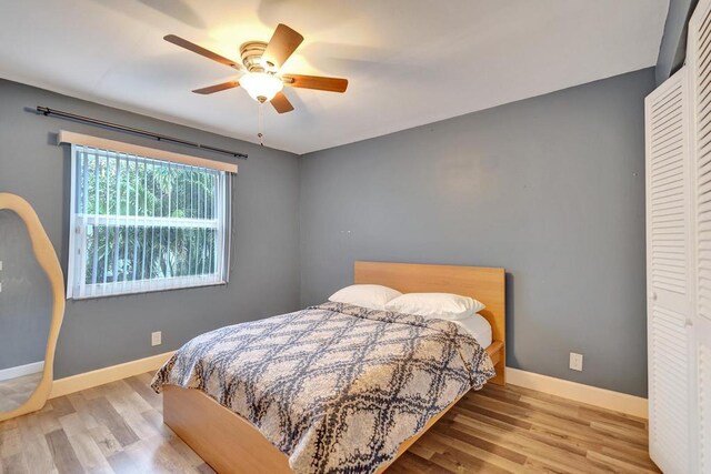 bedroom with ceiling fan and hardwood / wood-style floors