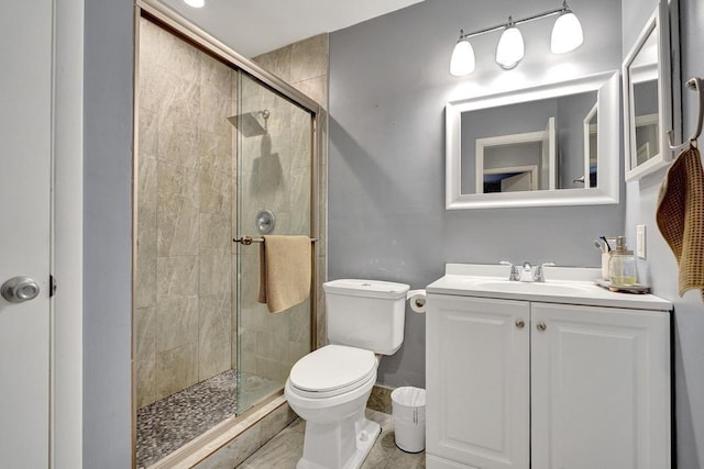 full bathroom with a stall shower, vanity, and toilet