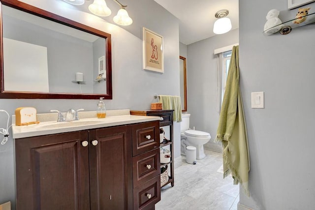 bathroom featuring toilet and vanity