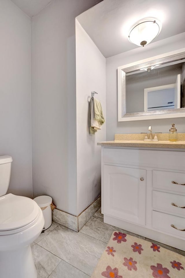 bathroom with toilet and vanity