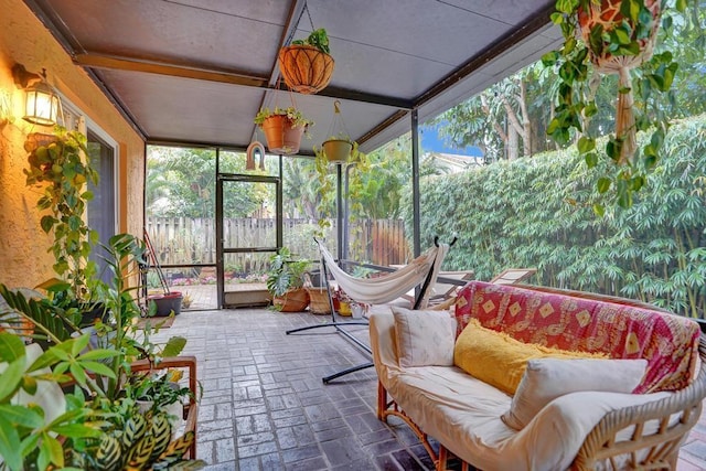 sunroom featuring beamed ceiling