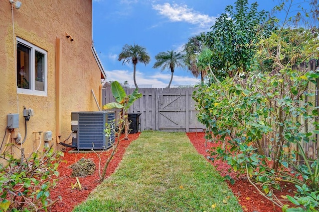 view of yard featuring fence and central AC unit