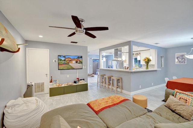 living room featuring baseboards, visible vents, ceiling fan, and recessed lighting