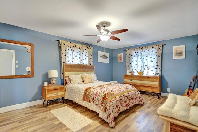 bedroom featuring wood finished floors, a ceiling fan, and baseboards