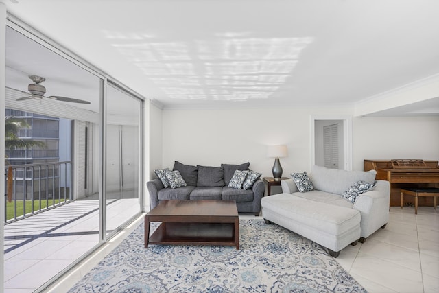 living room featuring ceiling fan, expansive windows, light tile patterned flooring, and crown molding