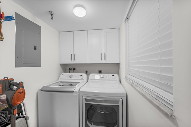 laundry area with cabinets, independent washer and dryer, and electric panel