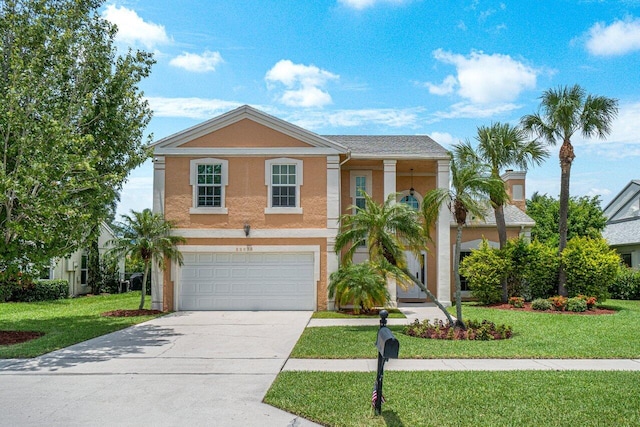 view of front of house featuring a front lawn and a garage