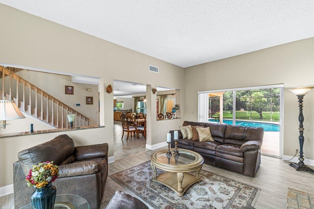 living room featuring a textured ceiling and light wood-type flooring