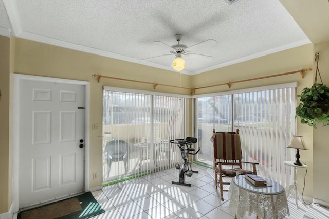 sunroom / solarium featuring ceiling fan