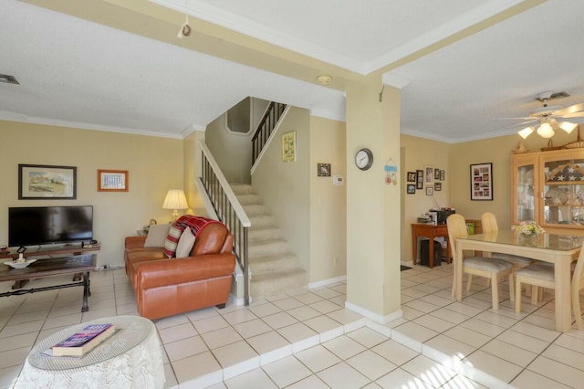 tiled living room with ceiling fan and ornamental molding