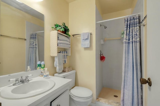 bathroom featuring toilet, vanity, and a shower with shower curtain