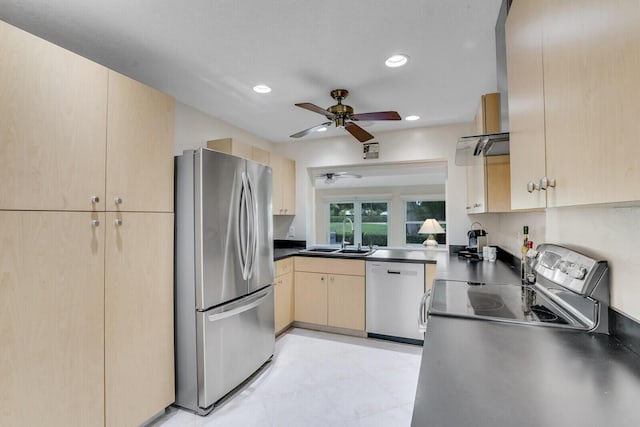 kitchen with stainless steel appliances, dark countertops, recessed lighting, light brown cabinets, and a sink