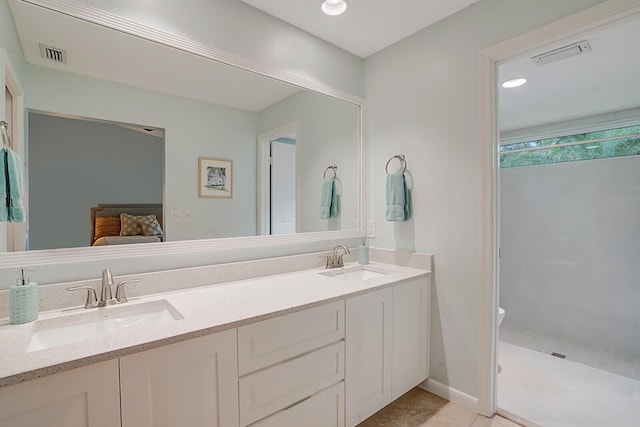 full bath with visible vents, a sink, ensuite bath, and double vanity