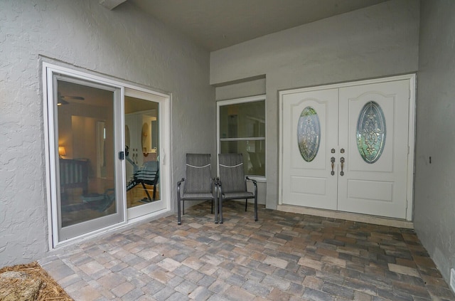 entrance to property with stucco siding