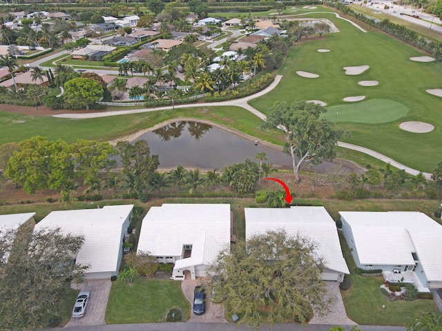 aerial view with a residential view, view of golf course, and a water view