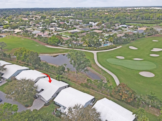 bird's eye view featuring a water view, view of golf course, and a residential view