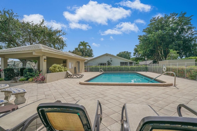 pool featuring a patio and fence