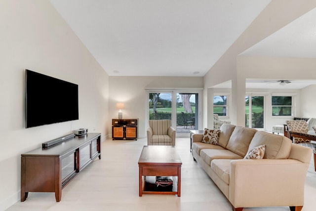 living room with light wood-style flooring and baseboards