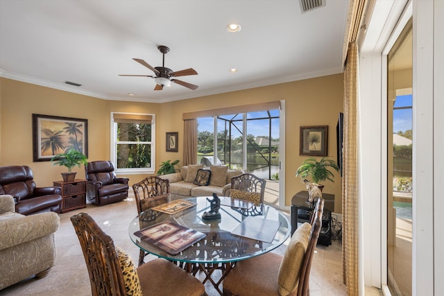 dining room with light tile patterned floors, ceiling fan, and ornamental molding