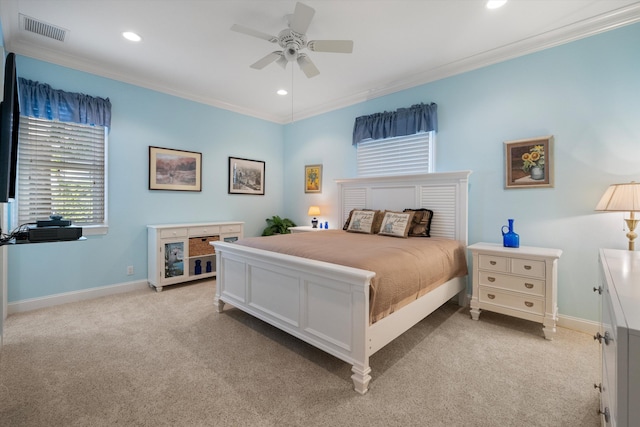 carpeted bedroom featuring ceiling fan and crown molding