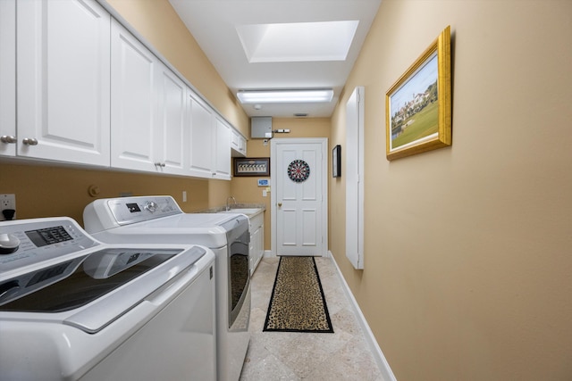 laundry room featuring washing machine and dryer and cabinets