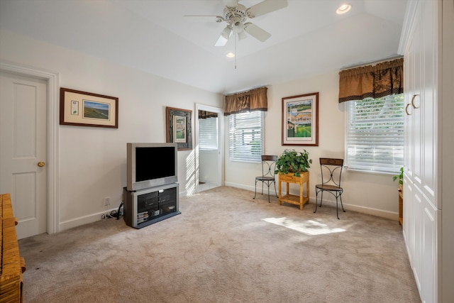 living area with plenty of natural light, ceiling fan, and light carpet