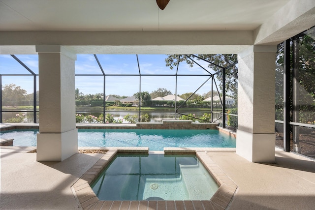 view of pool featuring an in ground hot tub, a patio, and a water view