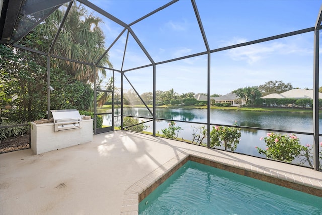 view of pool featuring grilling area, a water view, a patio, and glass enclosure