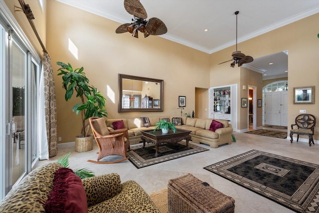 living room with ceiling fan, tile patterned flooring, and ornamental molding