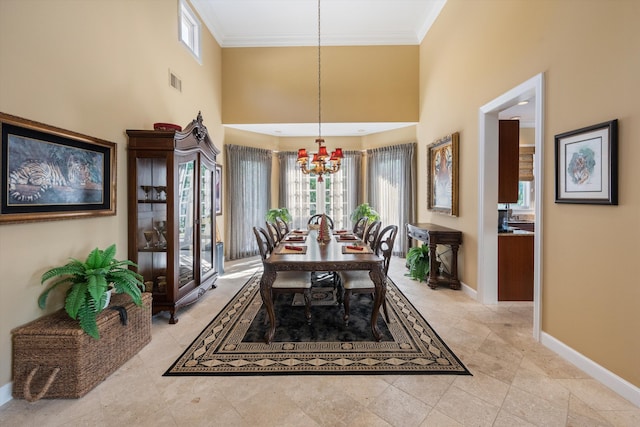 dining space with a high ceiling, an inviting chandelier, plenty of natural light, and ornamental molding