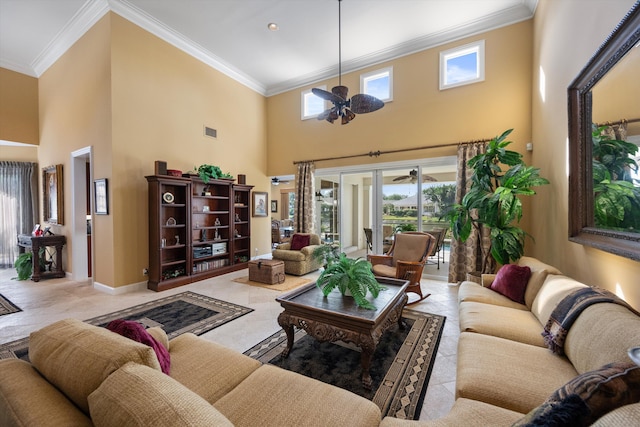 living room with ceiling fan, a towering ceiling, and ornamental molding