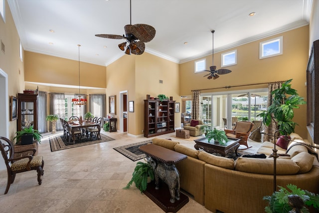 living room featuring a towering ceiling, ceiling fan, and crown molding