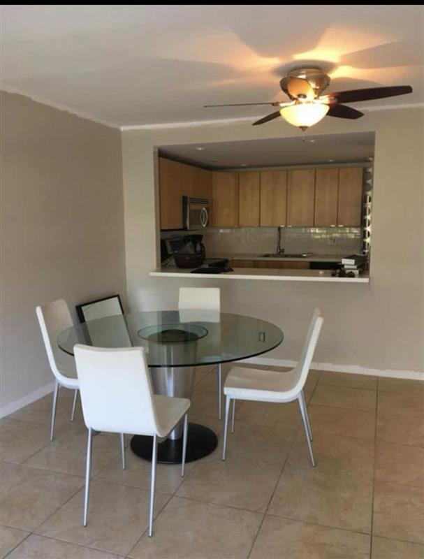 dining area featuring ceiling fan, light tile patterned floors, and sink