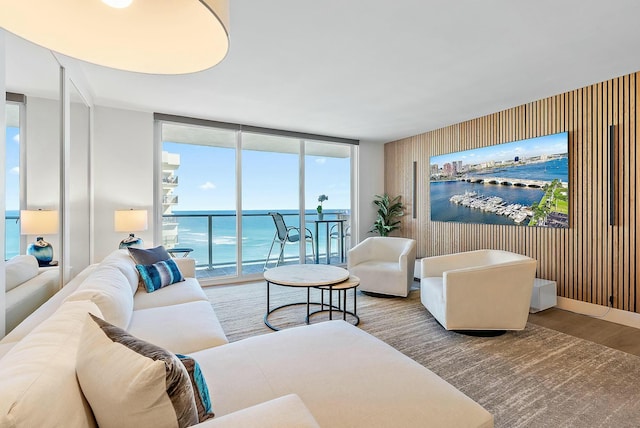 living room with a water view and expansive windows