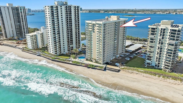 bird's eye view featuring a view of the beach and a water view