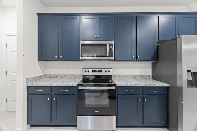 kitchen with blue cabinetry and appliances with stainless steel finishes