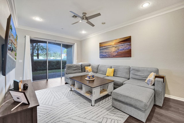 living room with hardwood / wood-style flooring, ceiling fan, and crown molding