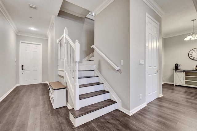 stairway with hardwood / wood-style flooring, a notable chandelier, and ornamental molding