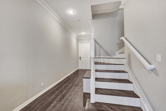 staircase featuring crown molding and hardwood / wood-style flooring