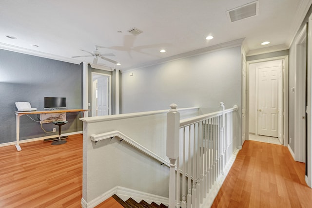 hallway featuring light hardwood / wood-style floors and ornamental molding