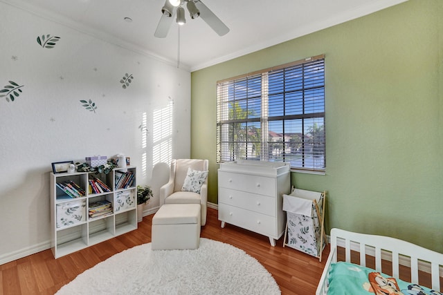 bedroom with wood-type flooring, ceiling fan, and crown molding