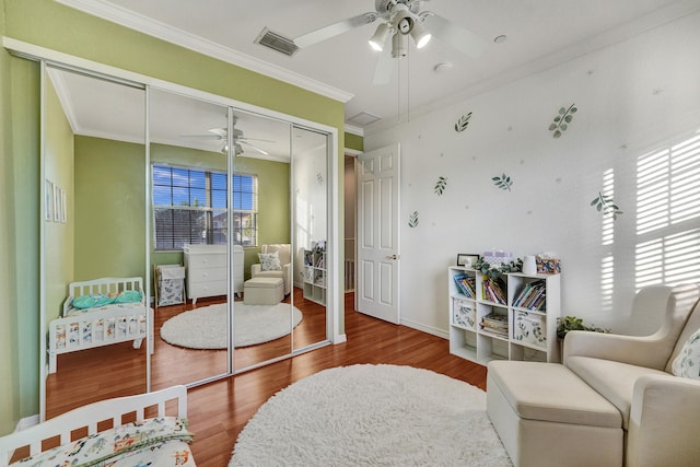 sitting room with hardwood / wood-style floors, plenty of natural light, and ornamental molding