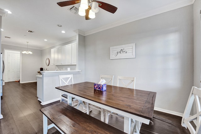 dining room with dark hardwood / wood-style flooring, ceiling fan with notable chandelier, and ornamental molding