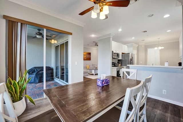 dining space with dark hardwood / wood-style flooring, ceiling fan with notable chandelier, and ornamental molding