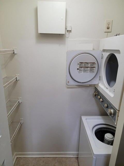 laundry area featuring stacked washer / dryer