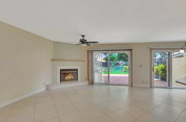 unfurnished living room featuring ceiling fan, light tile patterned floors, and a tile fireplace